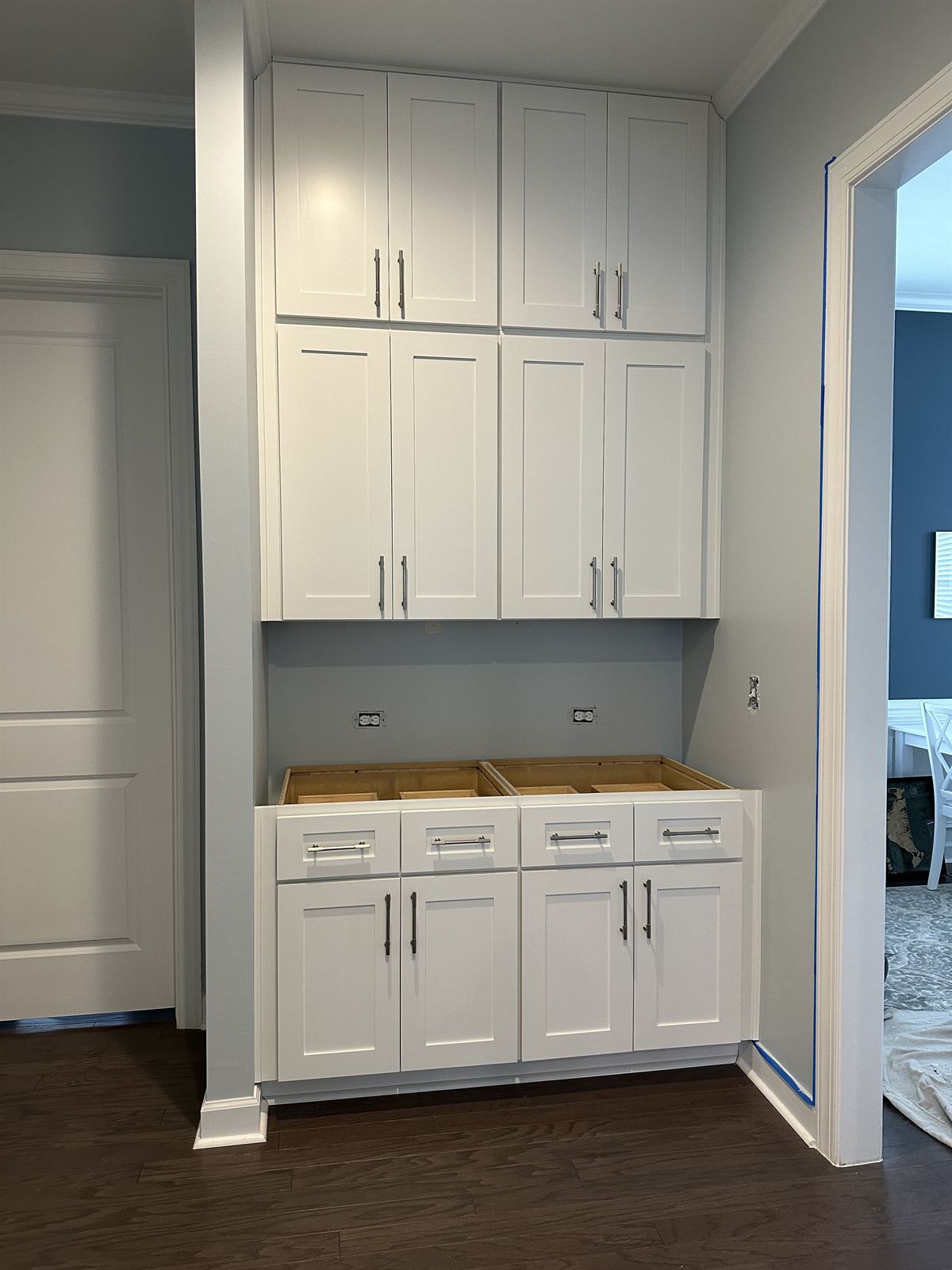 Custom carpentry built-in white cabinetry with shaker doors and drawers