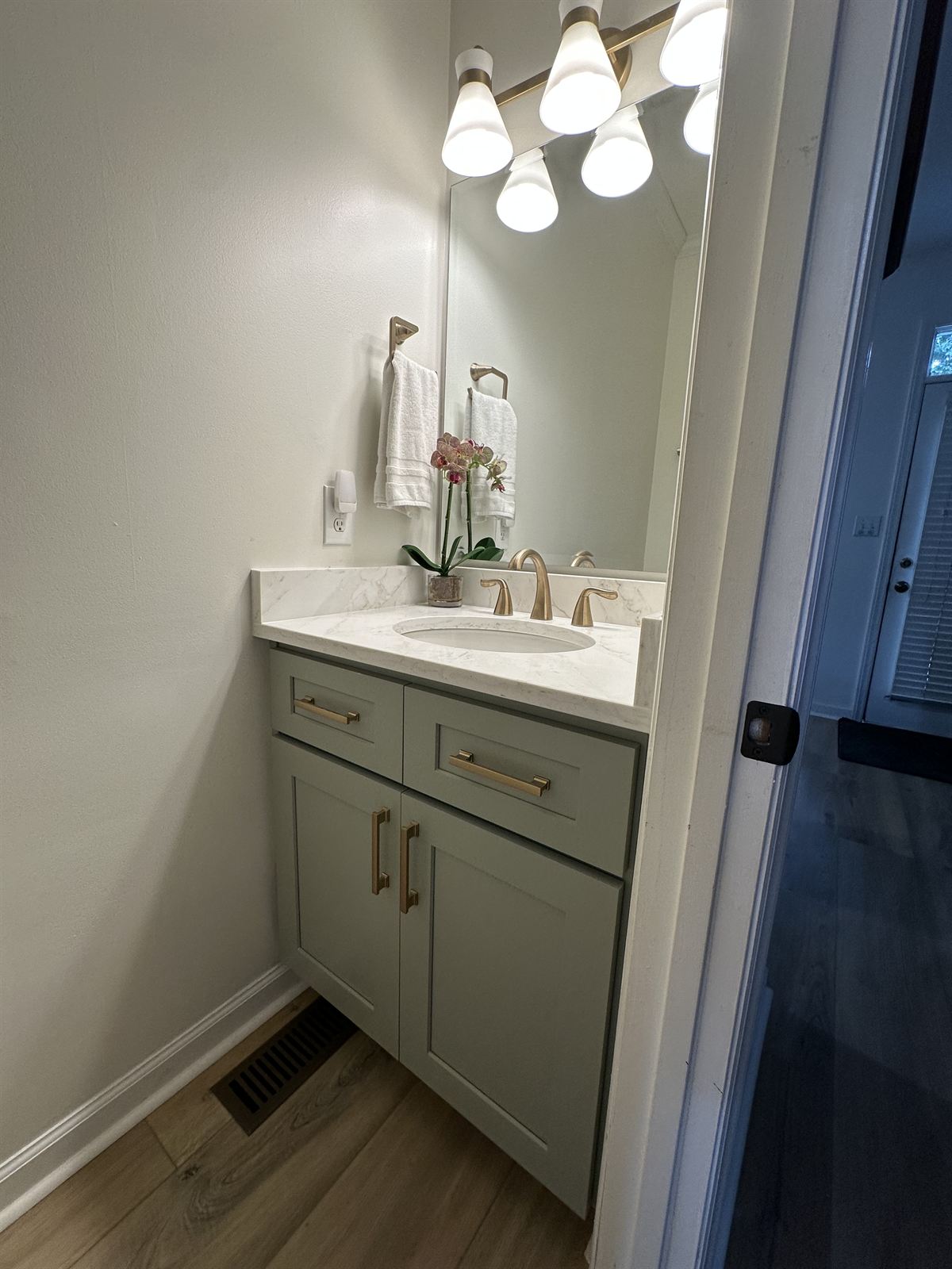 Powder room bathroom remodel with sage vanity, quartz top and brushed gold fixtures