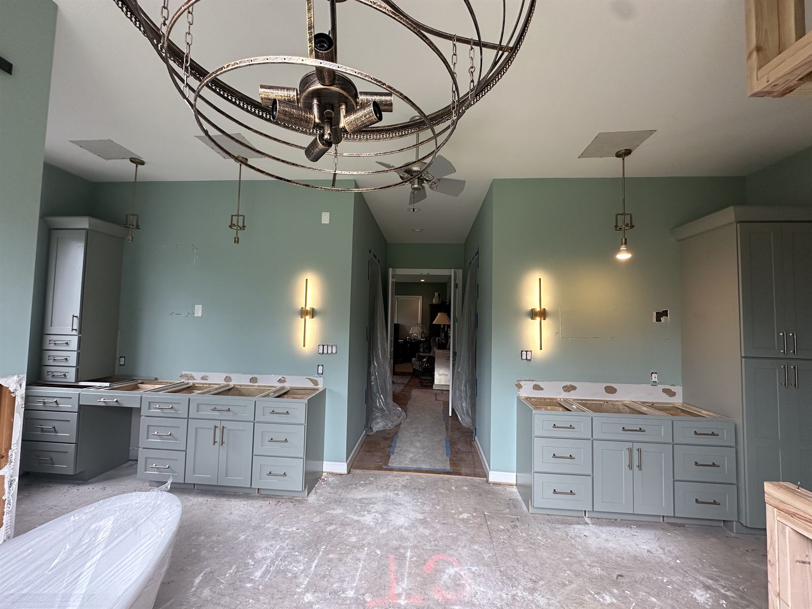Master bathroom remodel in progress with custom double vanities, freestanding tub and designer lighting