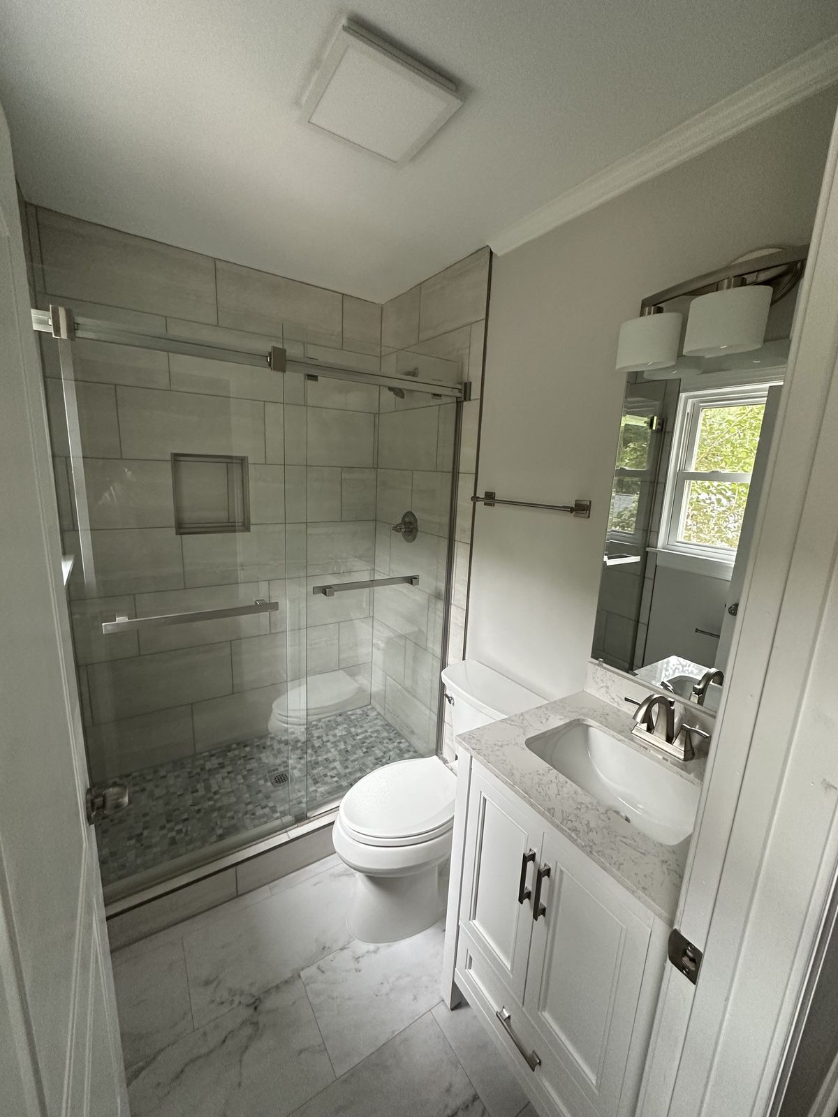 Master bathroom with vaulted ceiling, freestanding soaking tub and brass fixtures